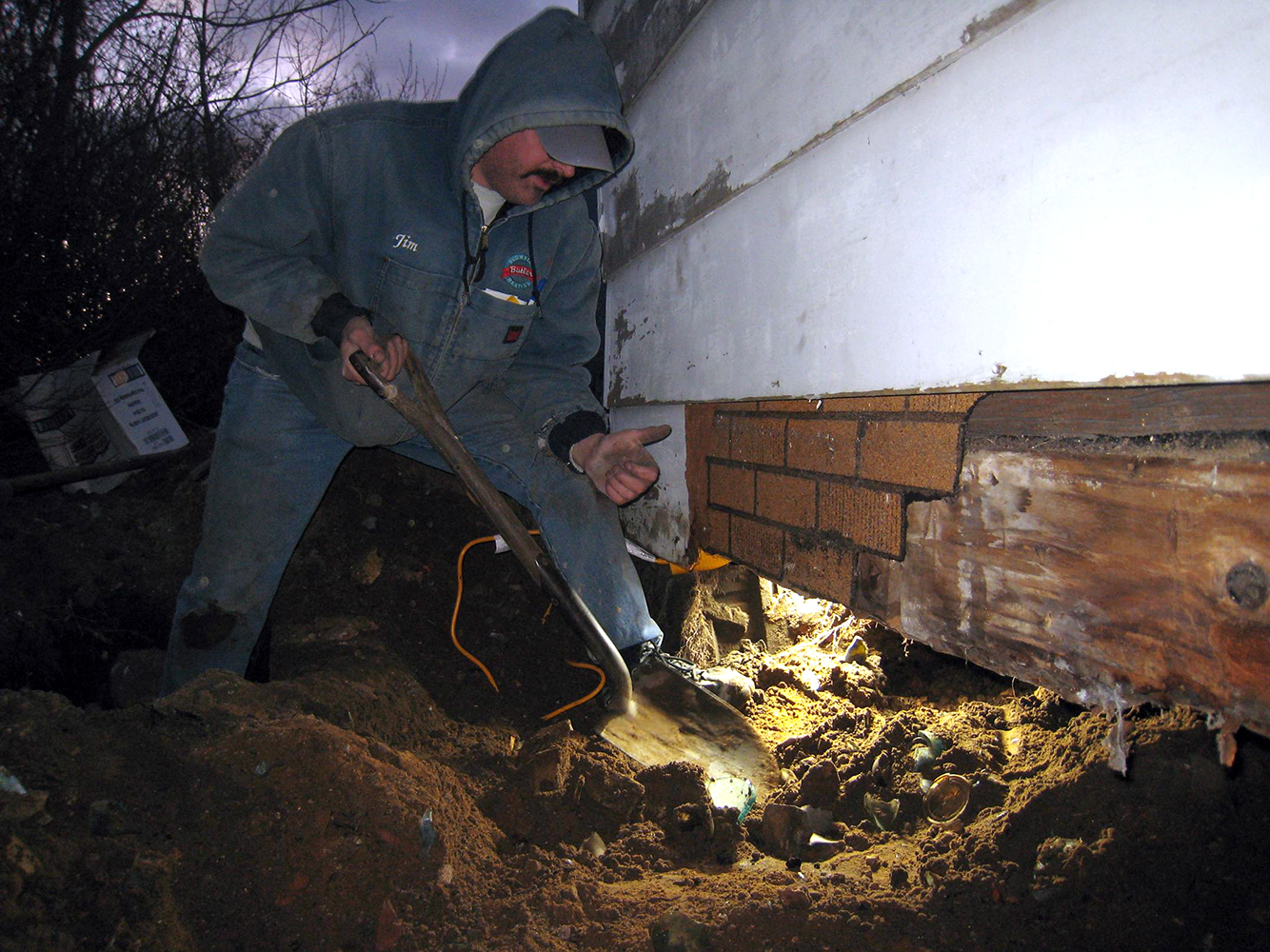 Jim digging beneath the rear addition of the house, shortly after a couple amazing amber blob top sodas were unearthed.